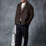 Dark brown double-breasted coat with notch lapels and flap pockets.