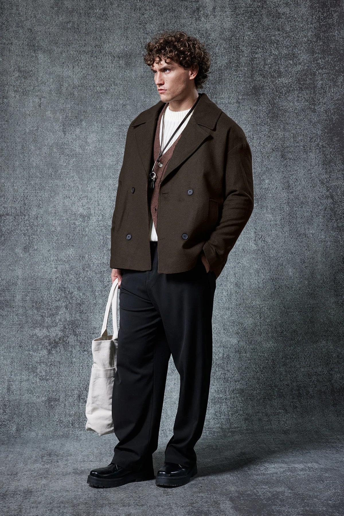 Dark brown double-breasted coat with notch lapels and flap pockets.