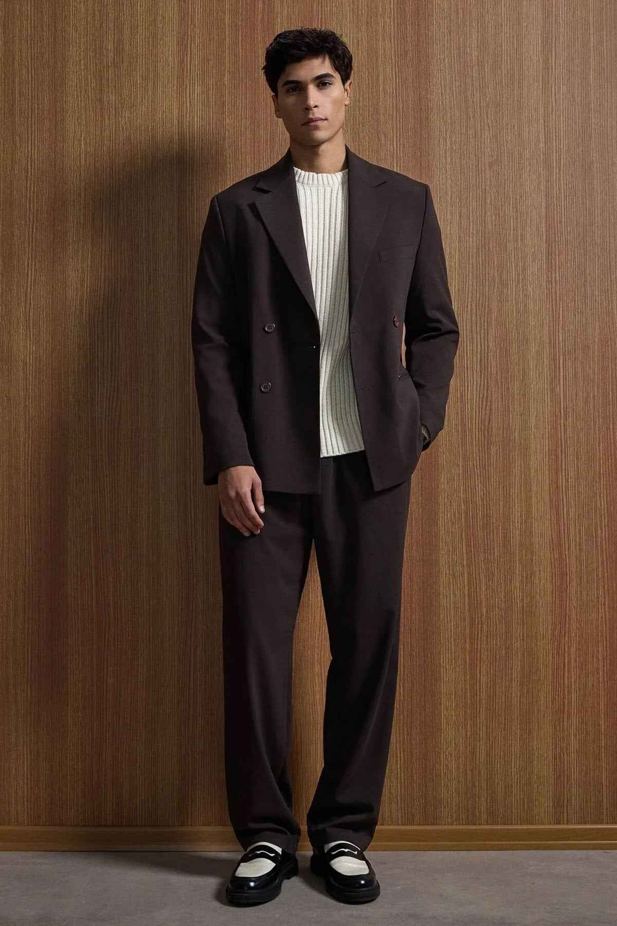 Men's dark brown oversized suit jacket and matching trousers with white ribbed shirt