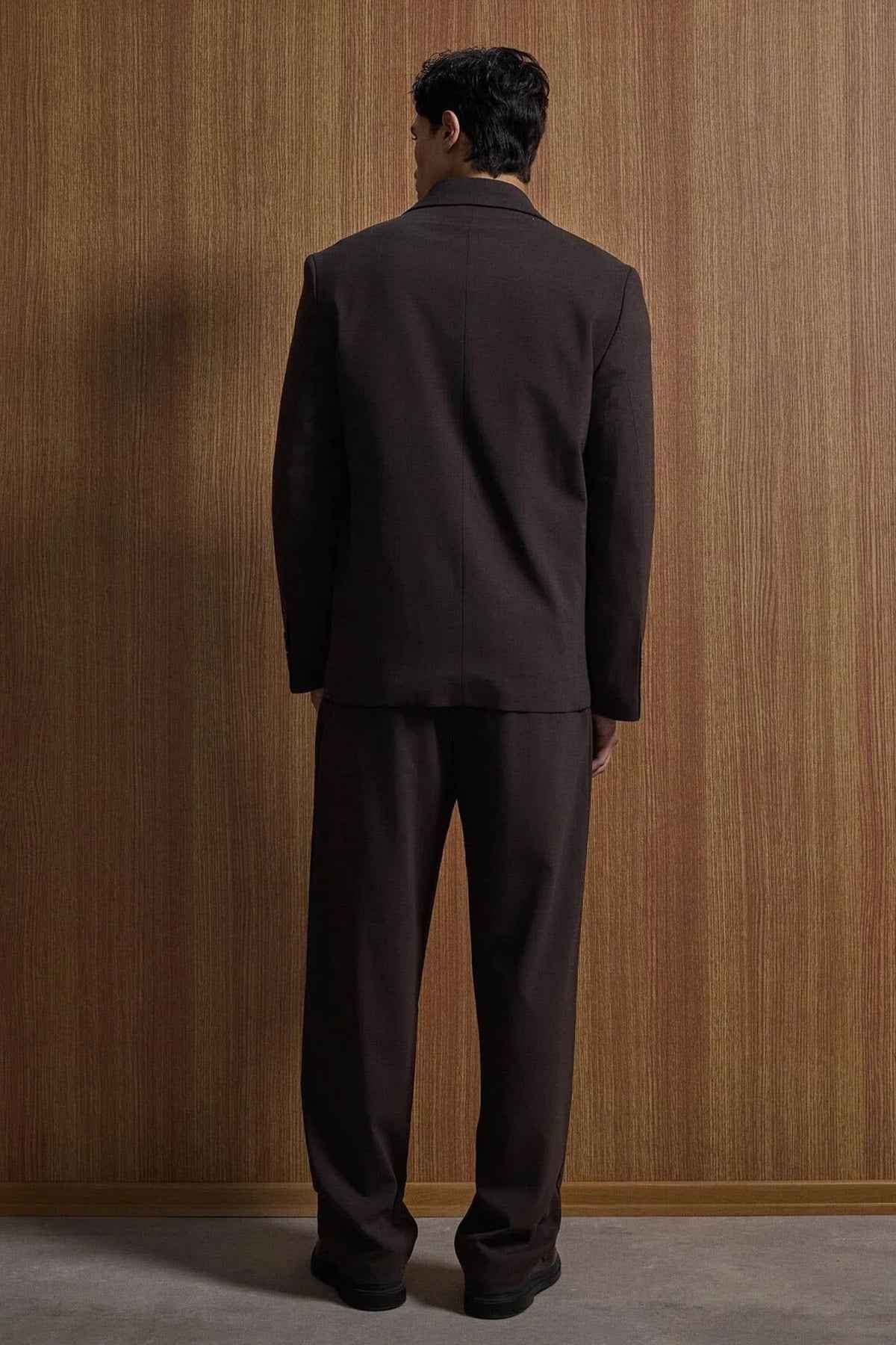 Men's dark brown suit jacket and matching trousers, back view