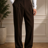 Men's brown pants with belt, side view, pleated front and wide-leg fit