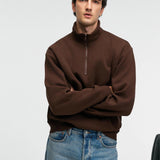 Brown relaxed-fit zip stand-collar sweatshirt, arms crossed front view