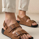 Brown suede sandals with two adjustable buckled straps and open toe, black rubber sole