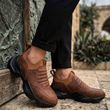 Brown suede sneakers with chunky black outsole and rear pull tab