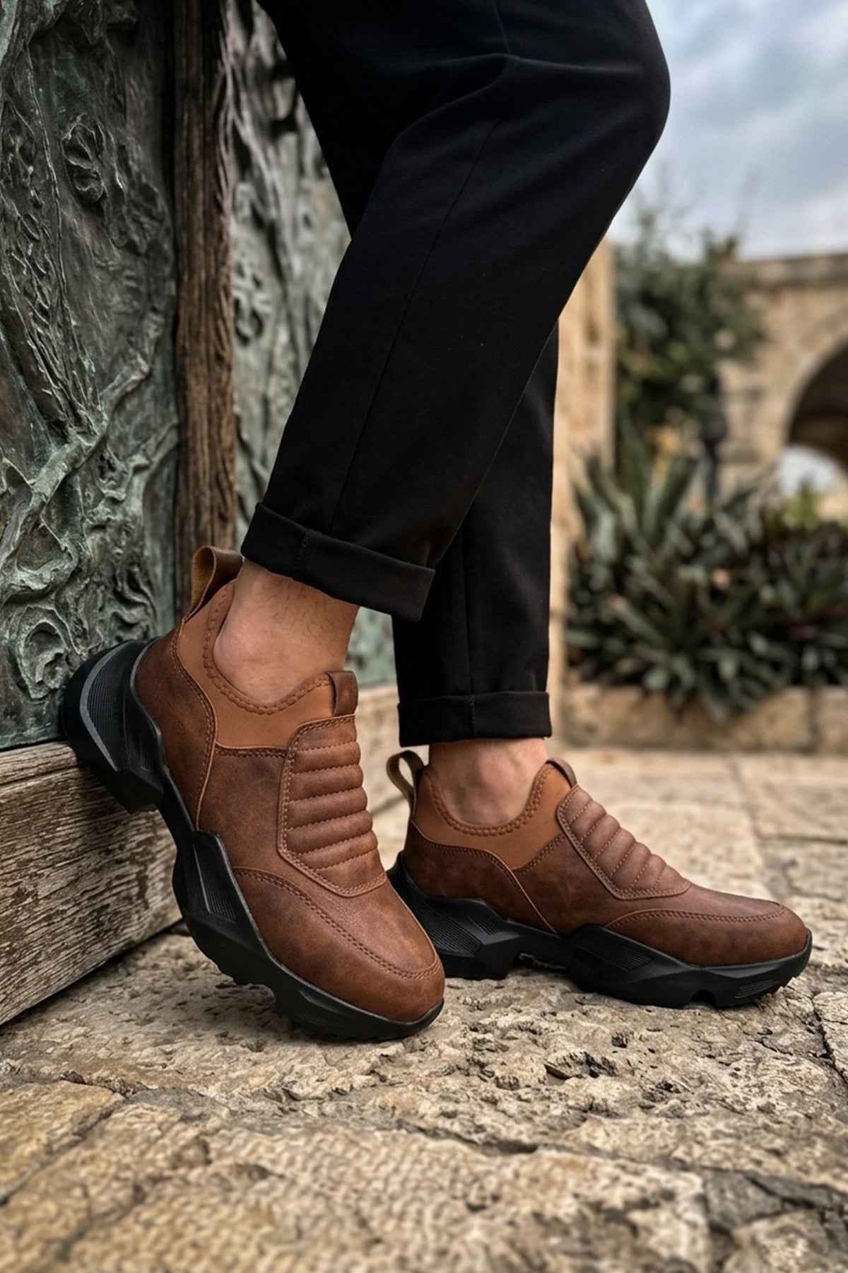Brown suede sneakers with chunky black outsole and rear pull tab