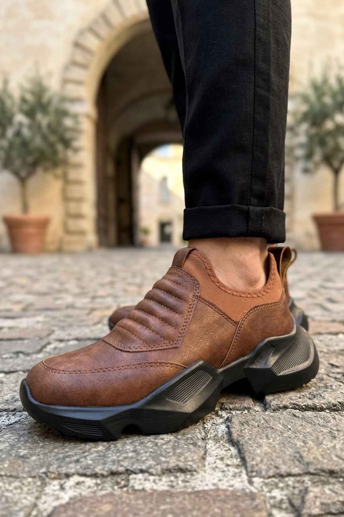 Brown suede sneakers with chunky outsole and elastic side panels
