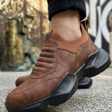 Brown suede sneaker with thick tread sole and elastic side panels