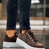 Men's brown sneakers with white chunky sole and lace-up detailing, side view