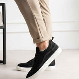Men's black canvas sneakers with white rubber sole and lace-up design