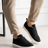 Men's black canvas sneakers with white sole, 3/4 front angle and lace-up