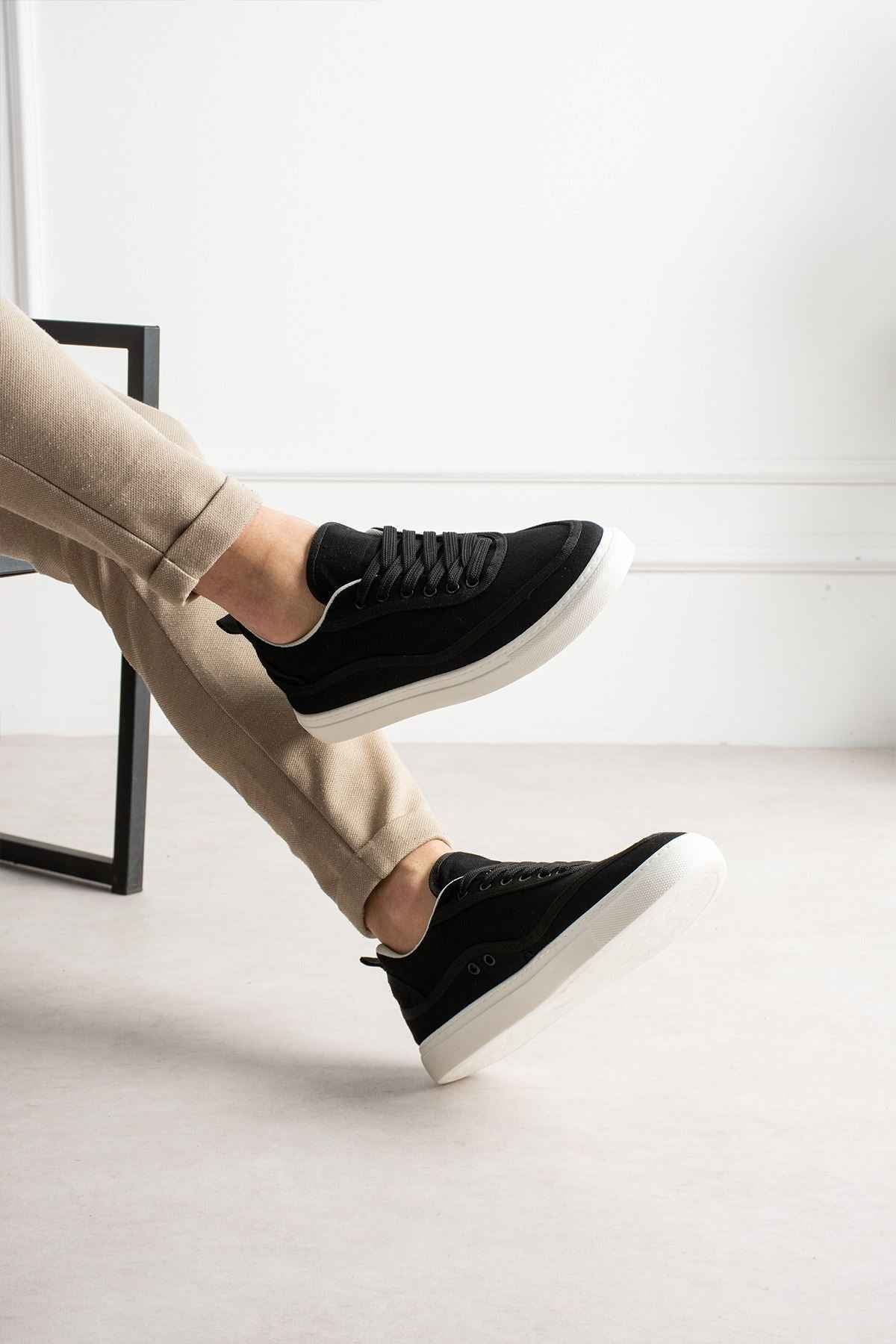 Men's black canvas sneakers with white sole, lace-up style