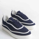 Dark blue canvas lace-up sneakers with white side stripes and white rubber sole