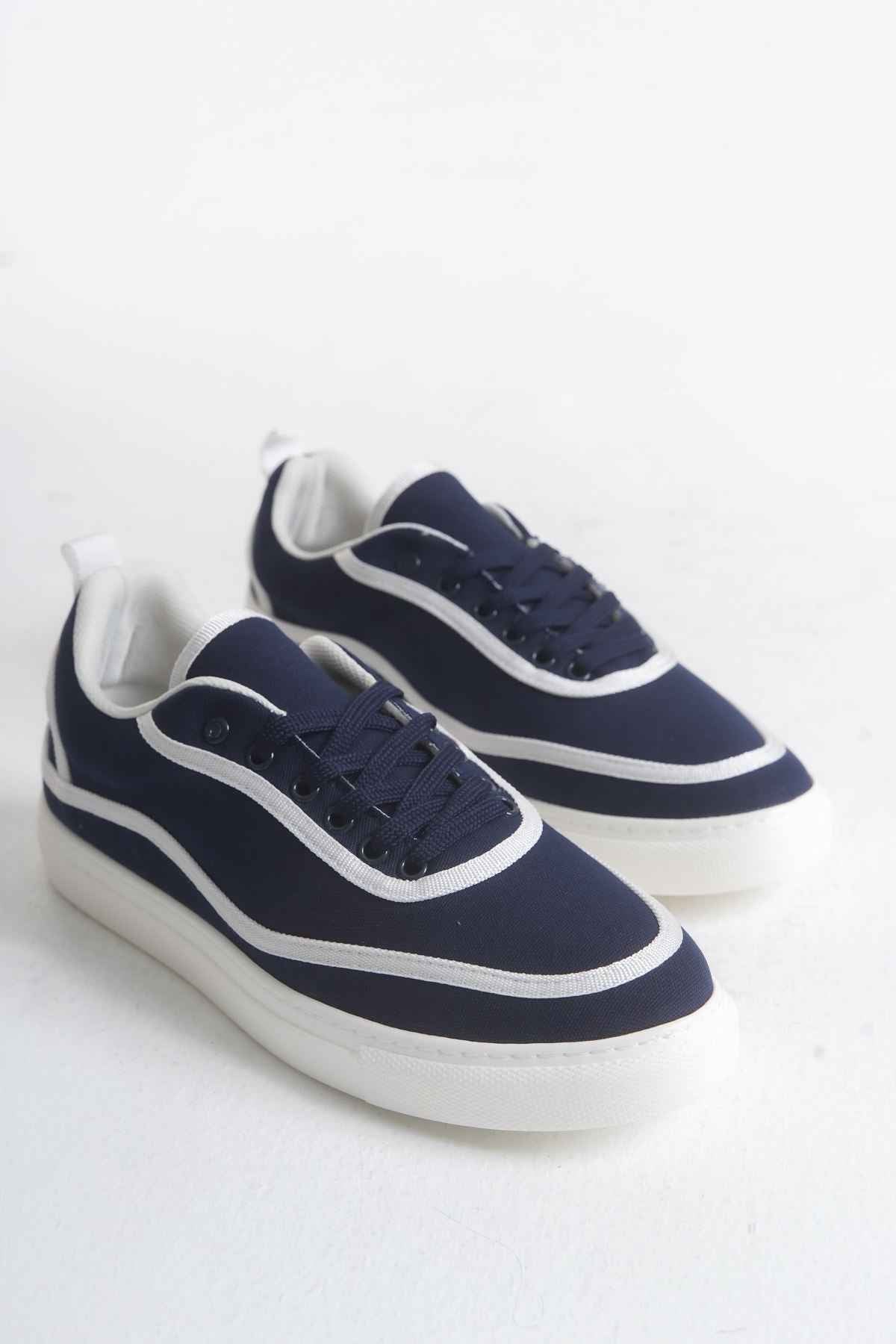 Dark blue canvas lace-up sneakers with white side stripes and white rubber sole