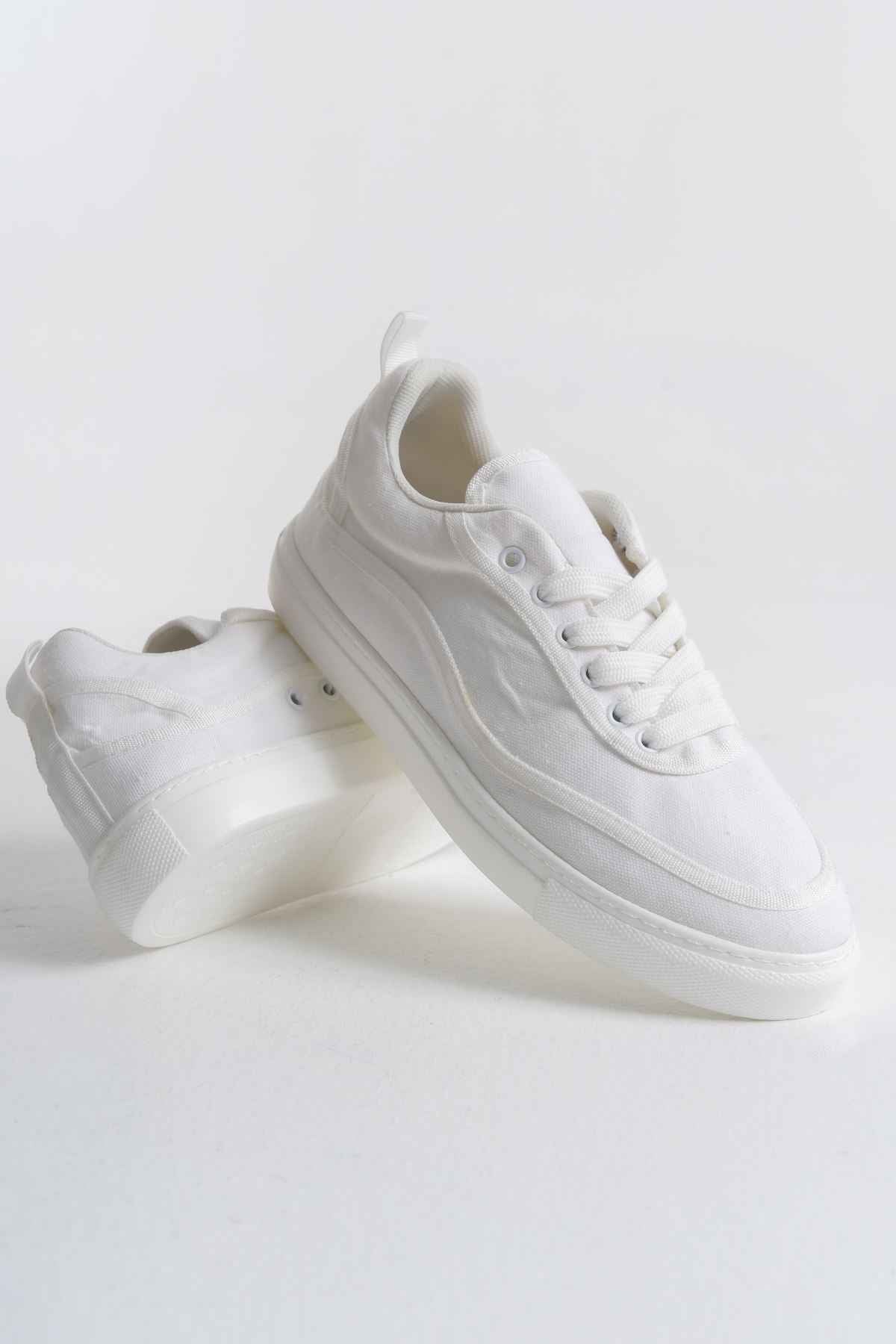 White canvas lace-up sneakers, side and heel view