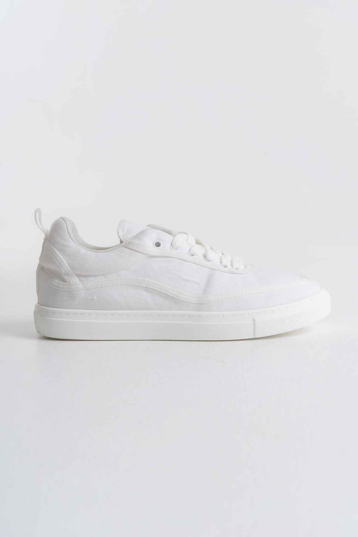 White canvas low-top sneakers with lace-up front