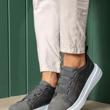 Men's dark gray low-top sneakers with strap closure and white midsole