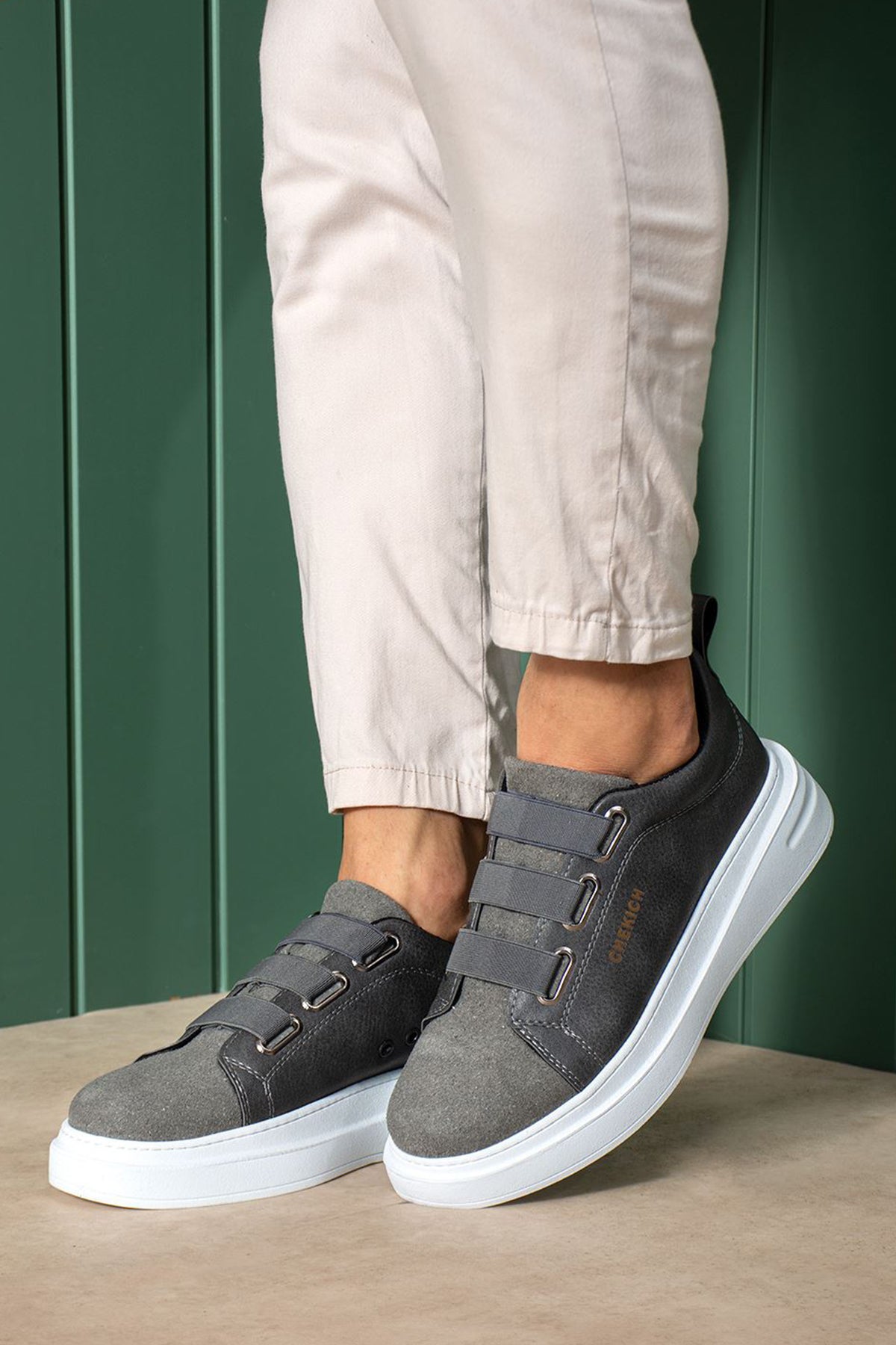 Men's dark gray low-top sneakers with strap closure and white midsole