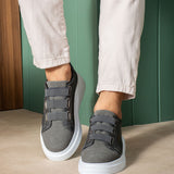 Dark gray casual sneakers with strap closure and white outsole