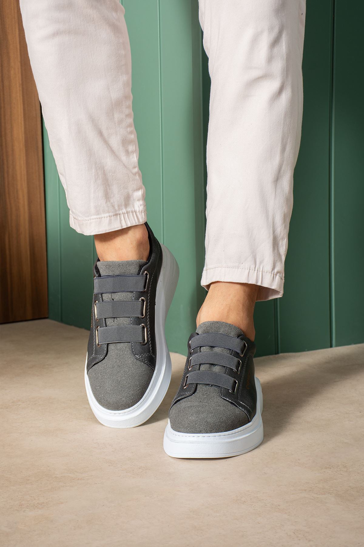 Dark gray casual sneakers with strap closure and white outsole