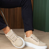 Beige casual sneakers angled view, double straps and white rubber sole
