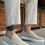 Light beige suede loafers, angled view, with V-shaped seam and low white sole