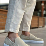 Light beige suede slip-on loafers with V-shaped seam and low white rubber sole