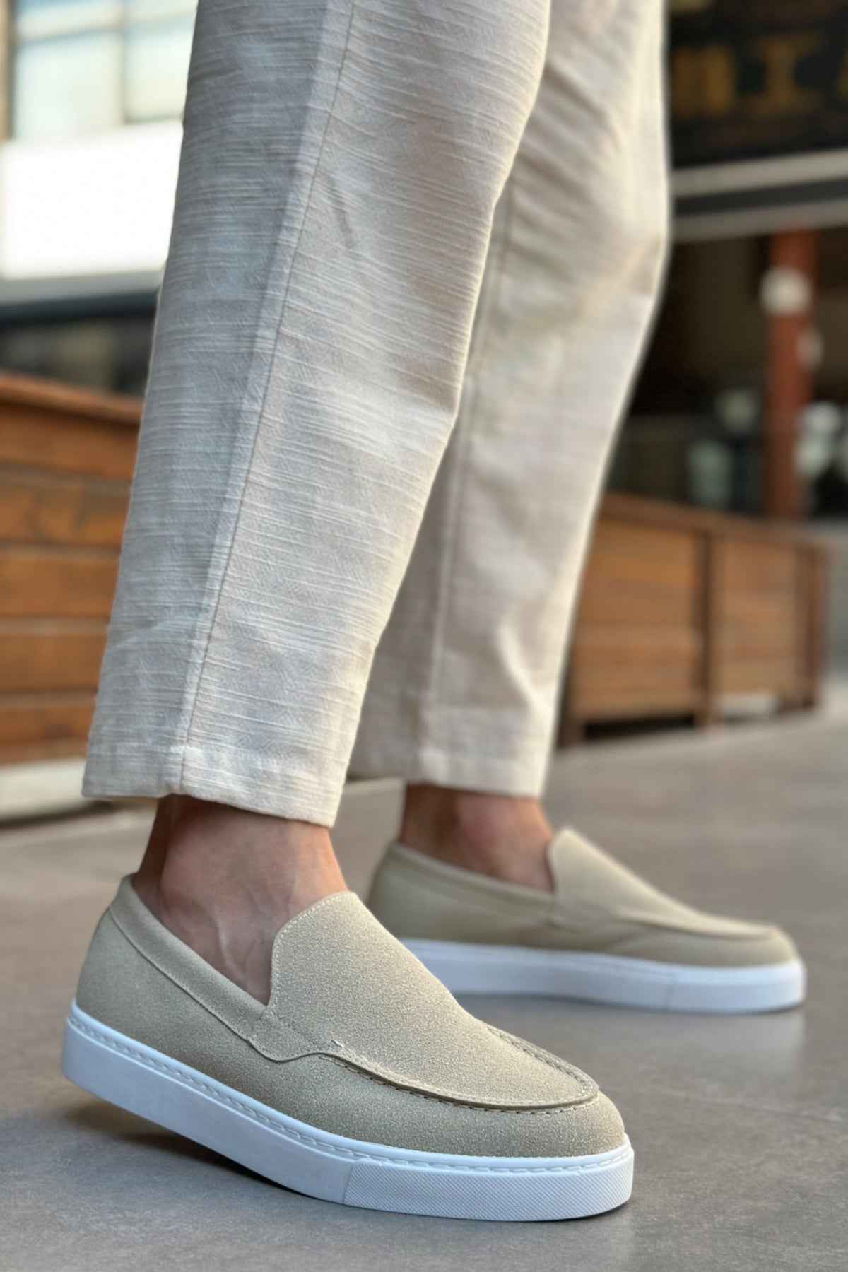 Light beige suede slip-on loafers with V-shaped seam and low white rubber sole