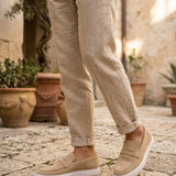 Men's beige suede loafer, standing view with white sole and slip-on design