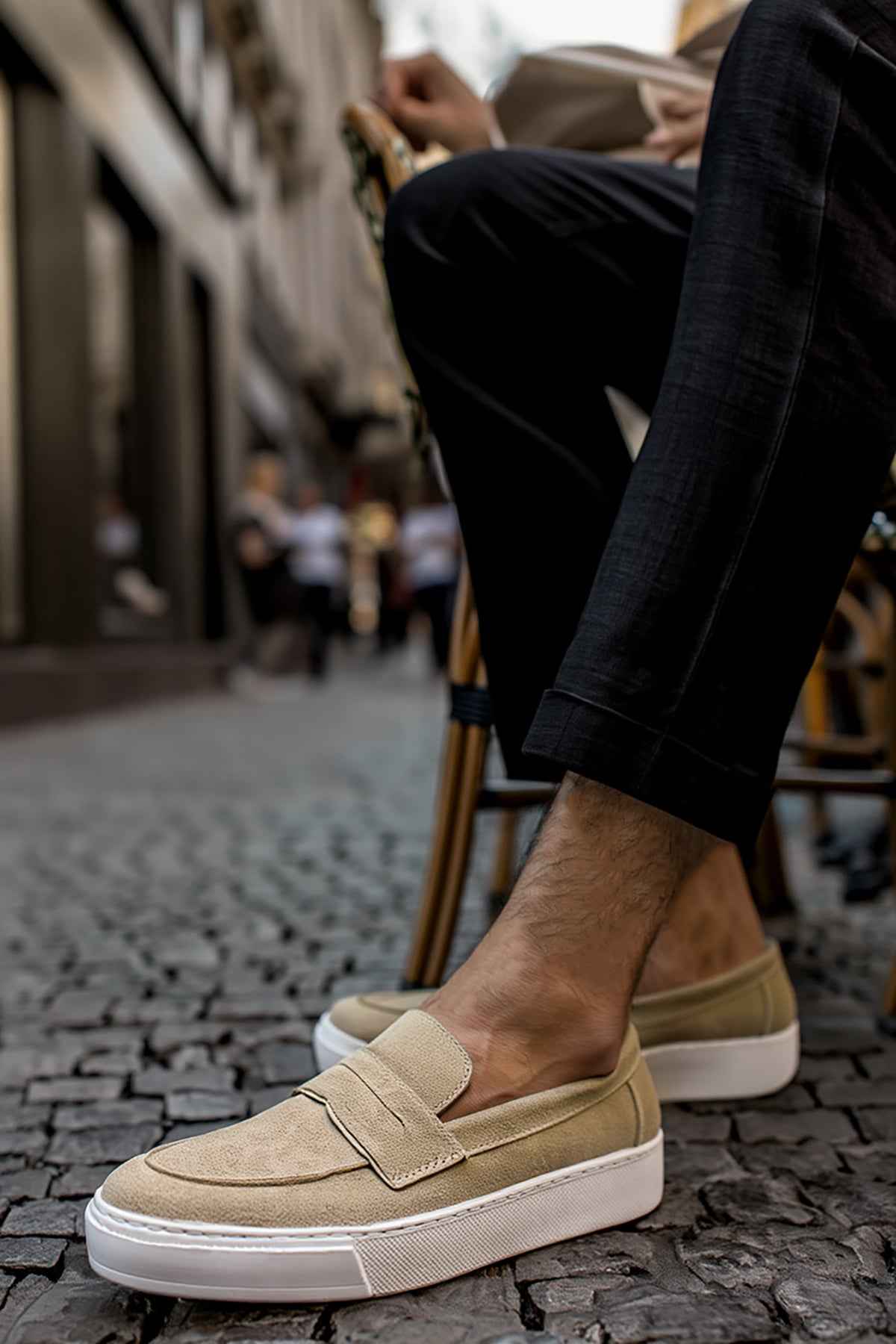 Beige suede men's loafers with slip-on strap and white rubber sole.