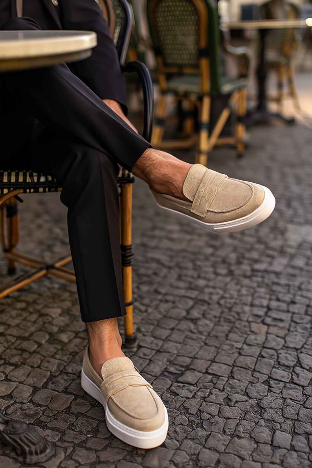 Beige suede loafers, low profile slip-on with white sole and side panel.