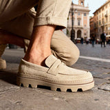 Men's beige suede loafers with strap detail and rugged tread sole