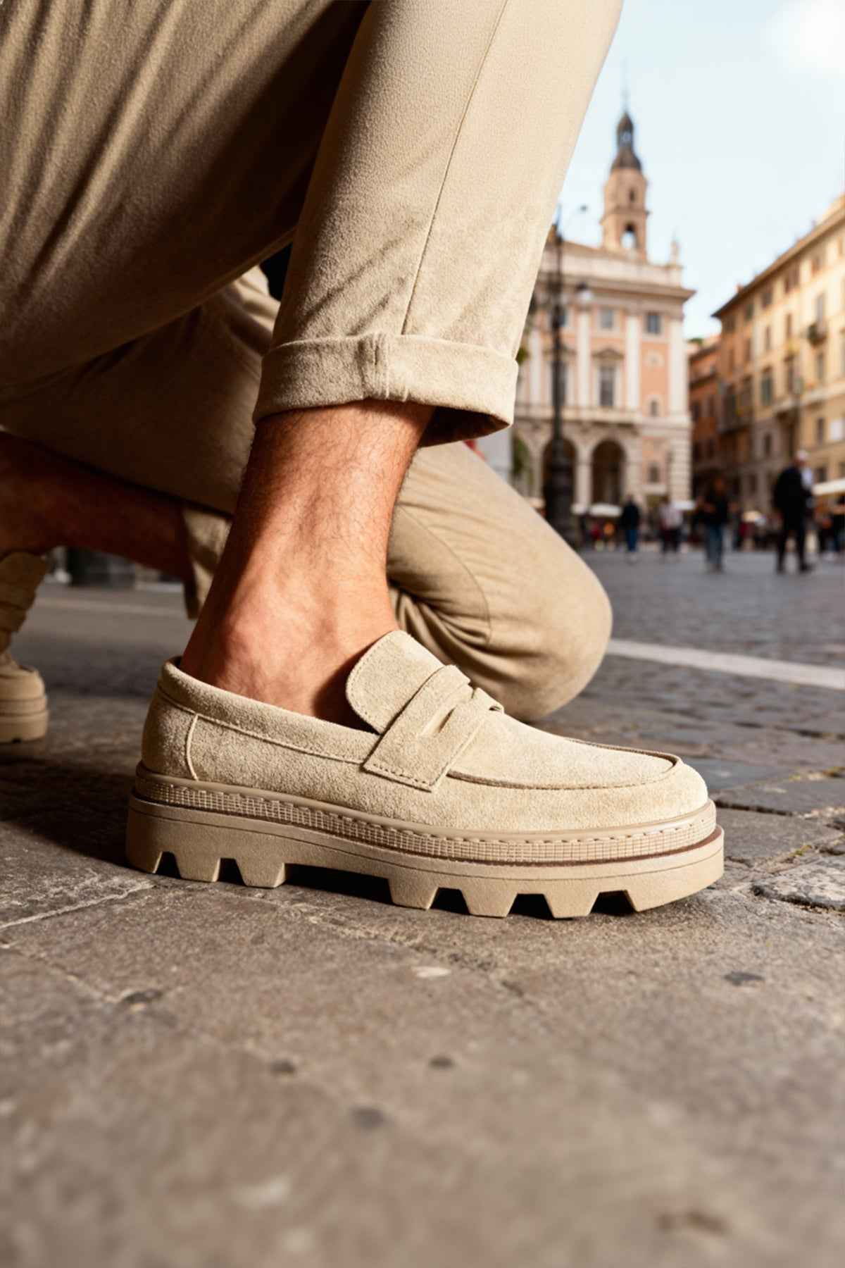 Men's beige suede loafers with strap detail and rugged tread sole