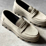 Pair of men's beige suede loafers with strap detail and rubber tread soles