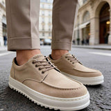 Beige suede lace-up shoes with textured sole, front side view