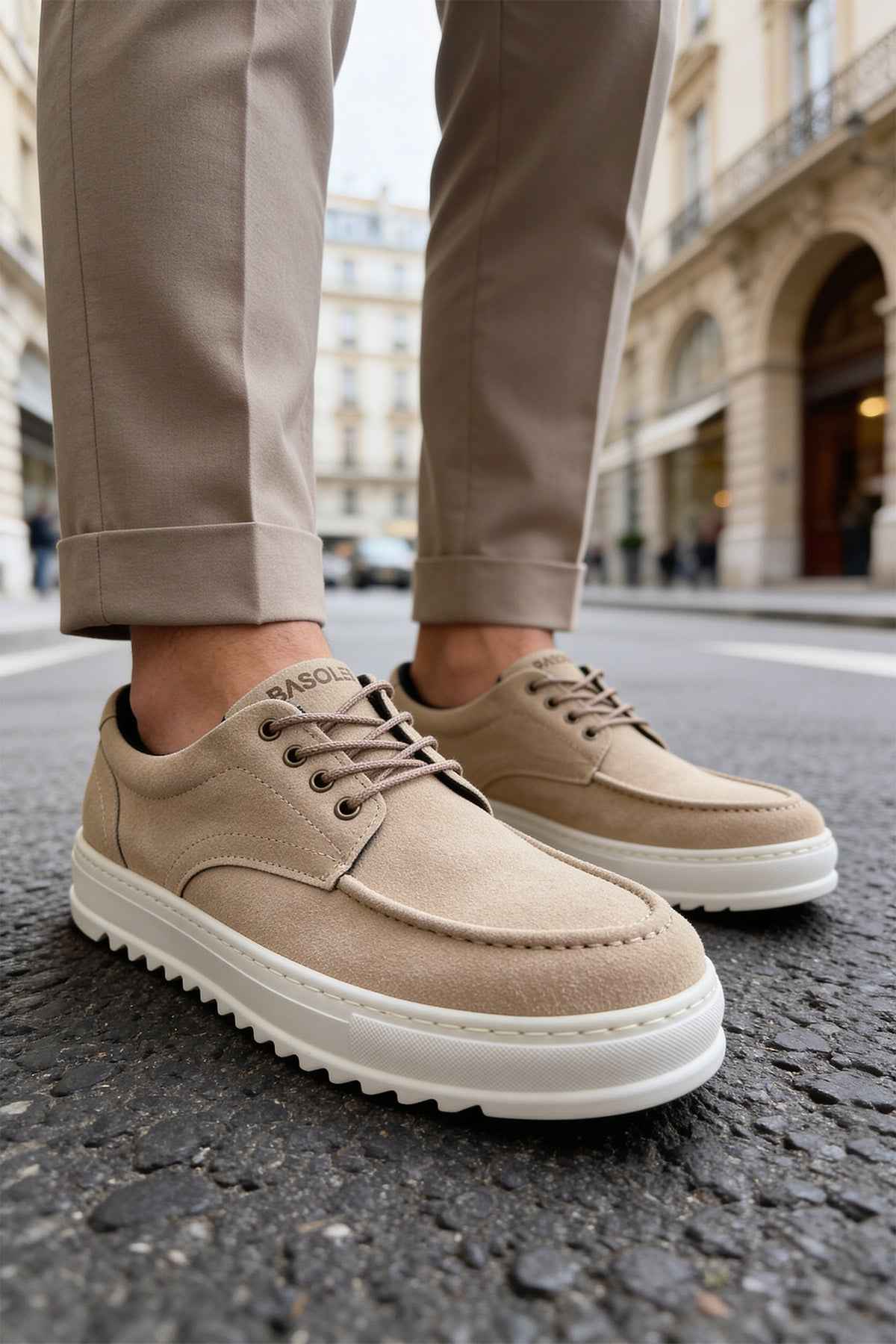 Beige suede lace-up shoes with textured sole, front side view