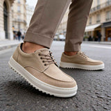 Beige suede lace-up sneakers with white sole, angled side view