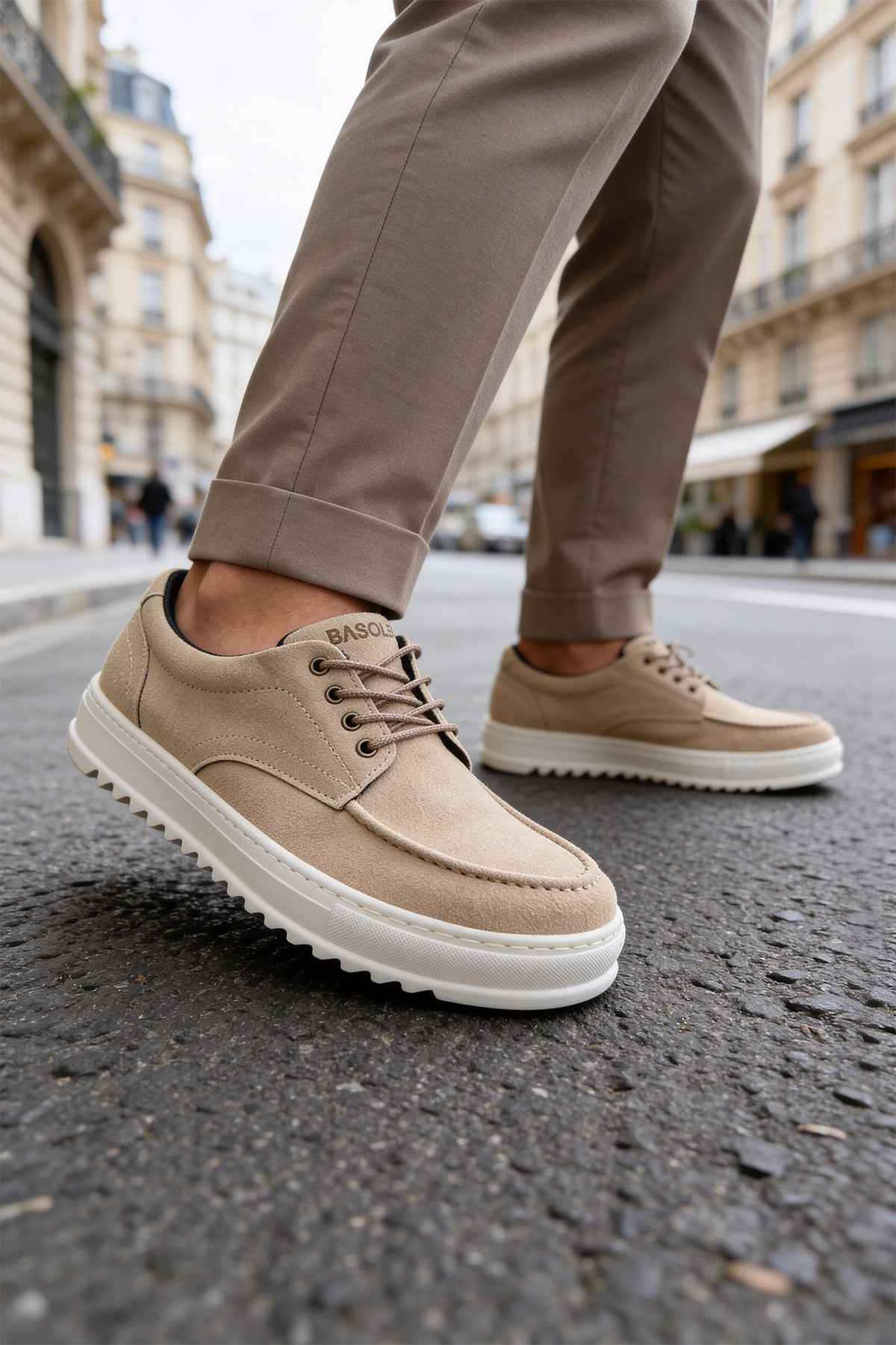 Beige suede lace-up sneakers with white sole, angled side view