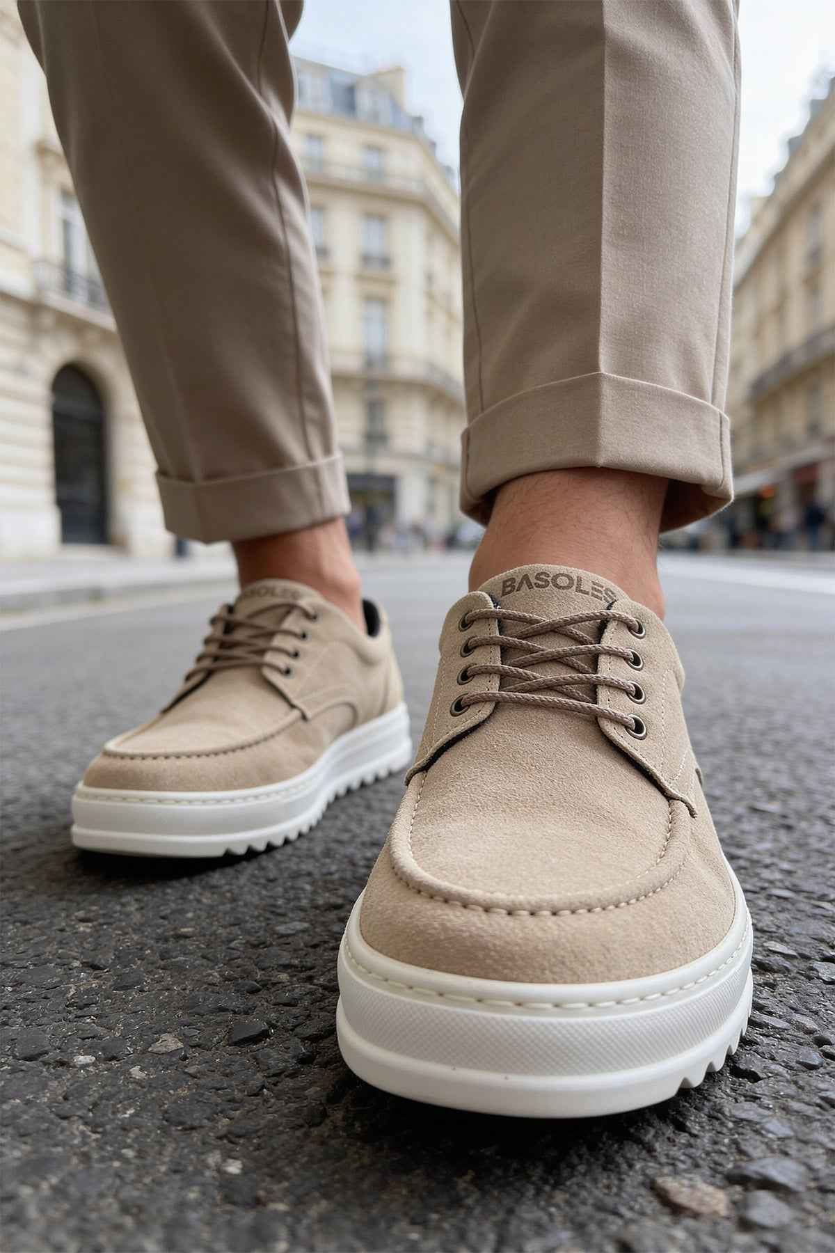 Beige suede lace-up shoes with stitched toe and white sole, close angle