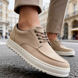 Beige suede lace-up sneakers with low profile white sole, close side view
