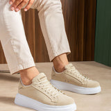 Beige lace-up suede sneakers on white soles worn with light trousers