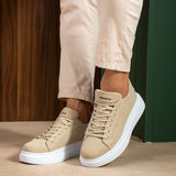 Beige suede sneakers with lace-up design and white sidewall sole