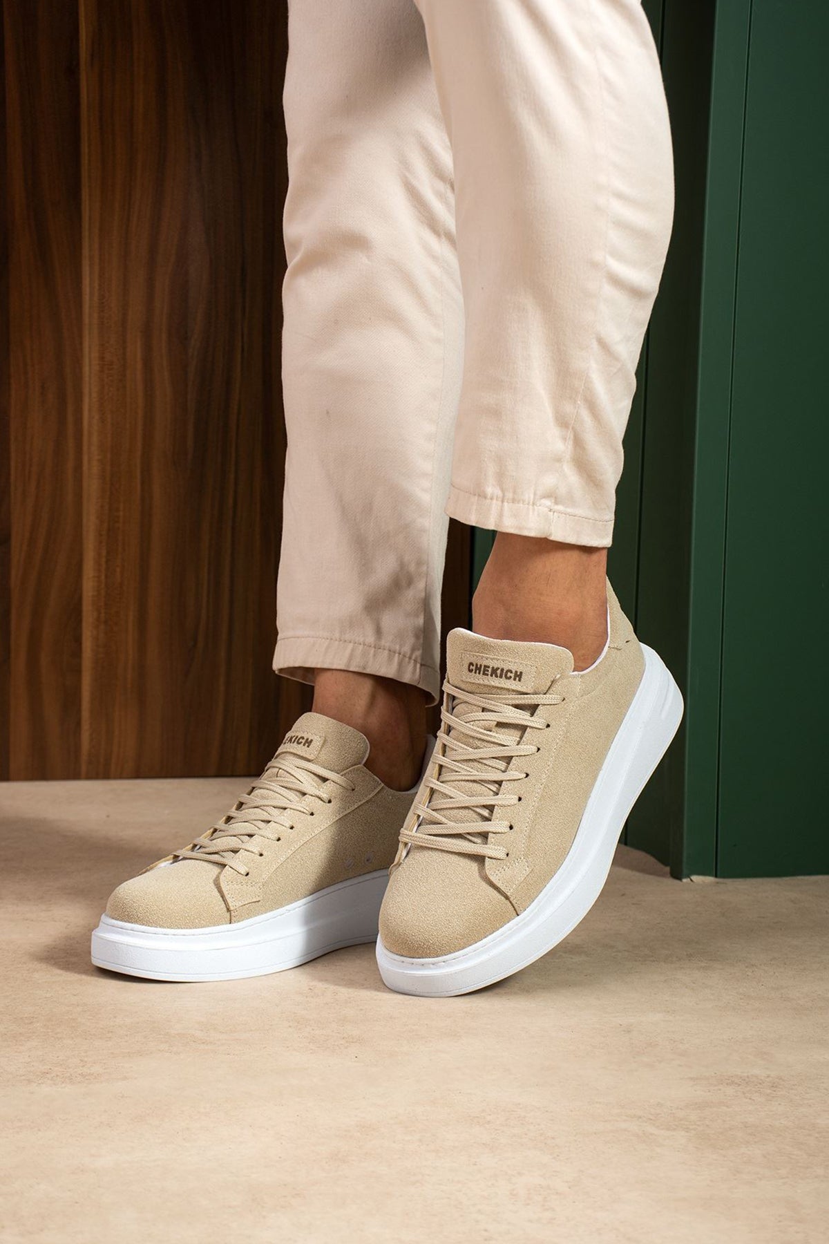 Beige suede sneakers with lace-up design and white sidewall sole