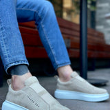 Beige suede slip-on sneakers with light blue rubber sole and side logo