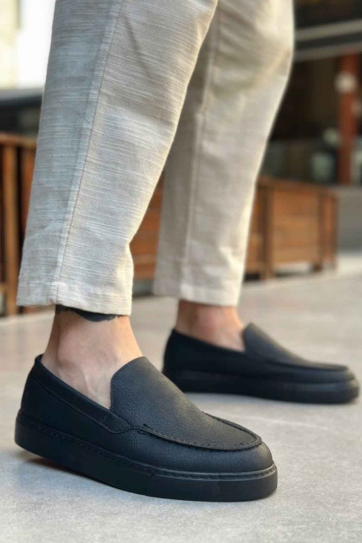 Men's black slip-on loafers, low profile with stitched apron and flat sole
