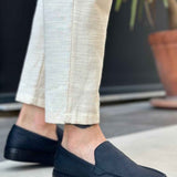 Men's black slip-on loafers with smooth upper and stitched detailing at vamp
