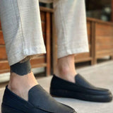 Men's black slip-on loafers with moc-toe seam detail and flat sole