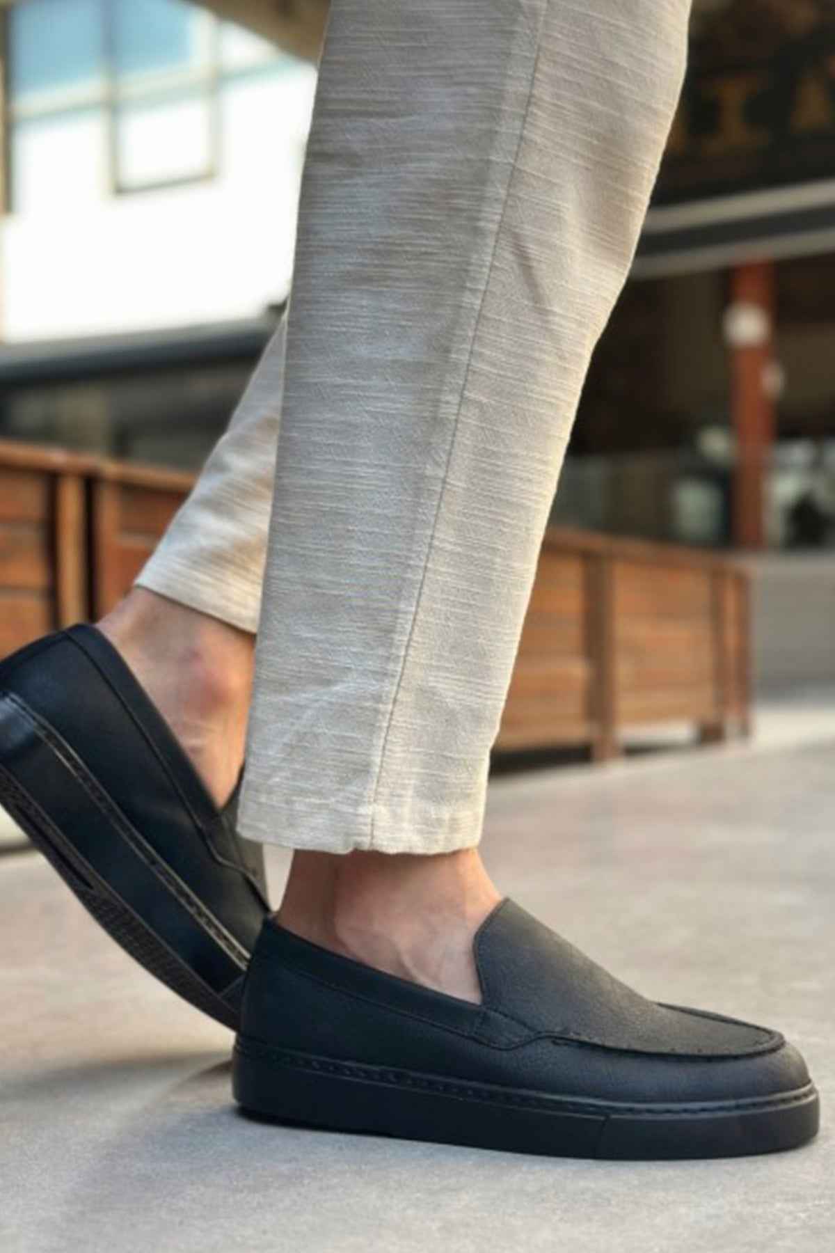Men's black loafers with side strap detail and stitched apron