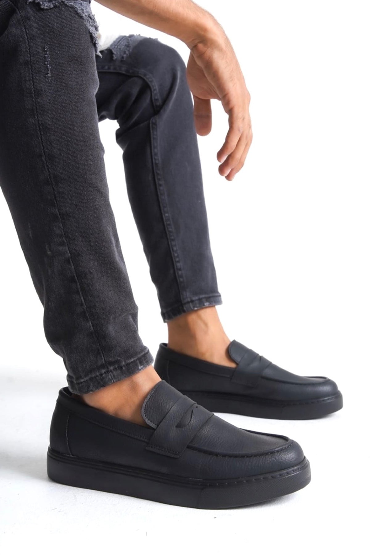 Men's black casual slip-on loafers with strap detail and low-profile sole