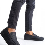 Men's black casual loafers, side view with strap, rounded toe, and thick sole