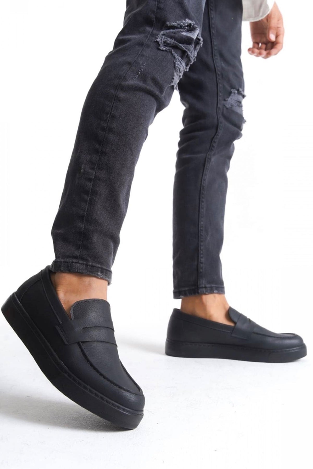 Men's black casual loafers, side view with strap, rounded toe, and thick sole